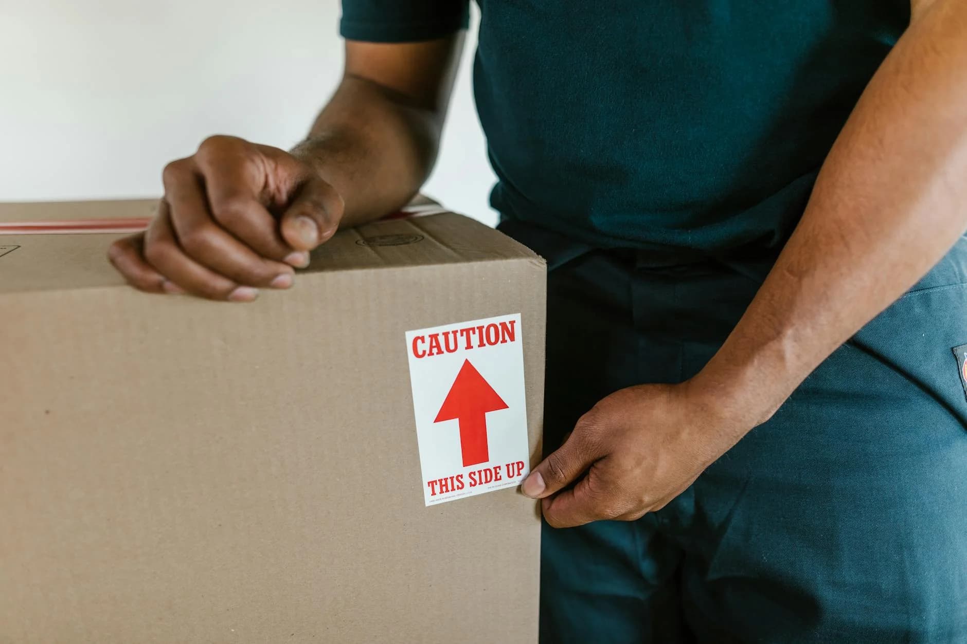 A Person Handling A Moving Box With A Ca 2