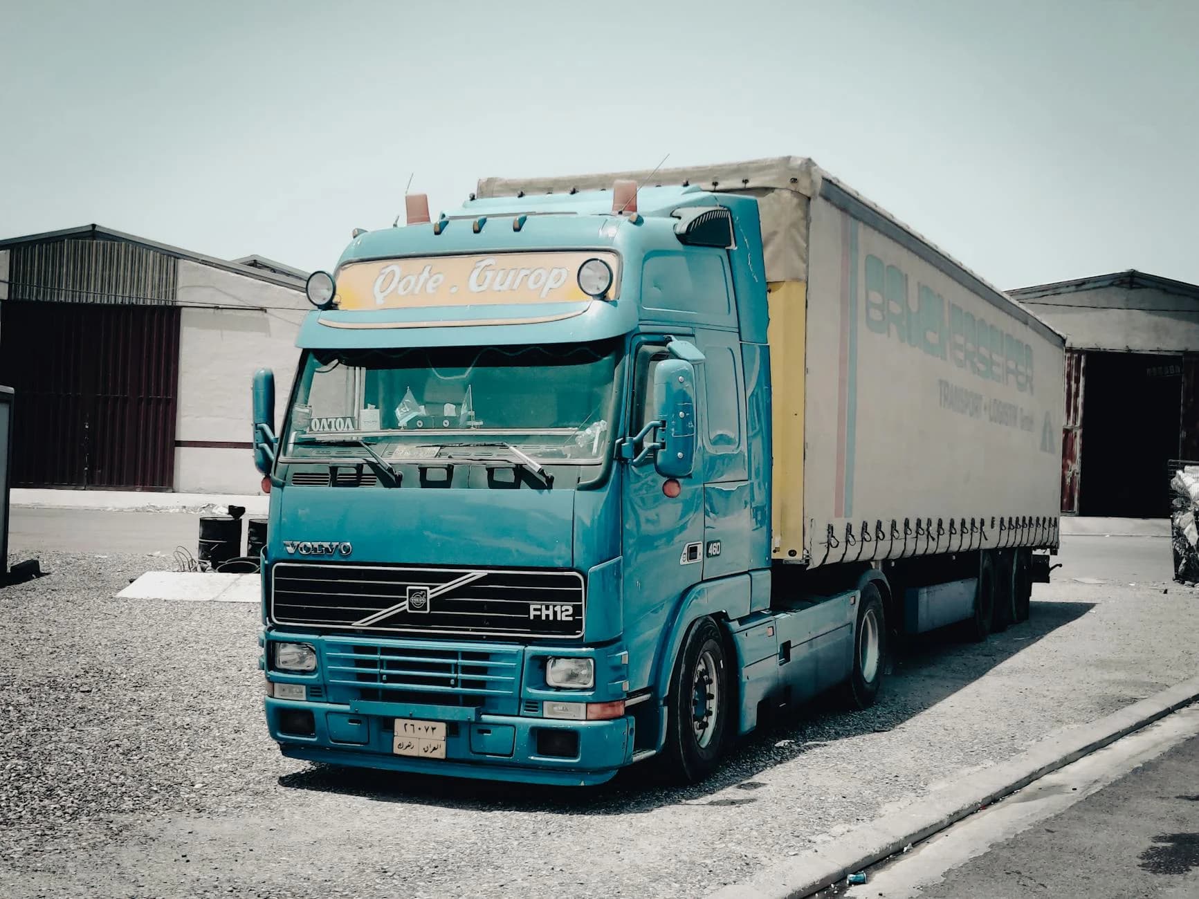 A Blue Volvo Truck Parked Outside A Ware 1