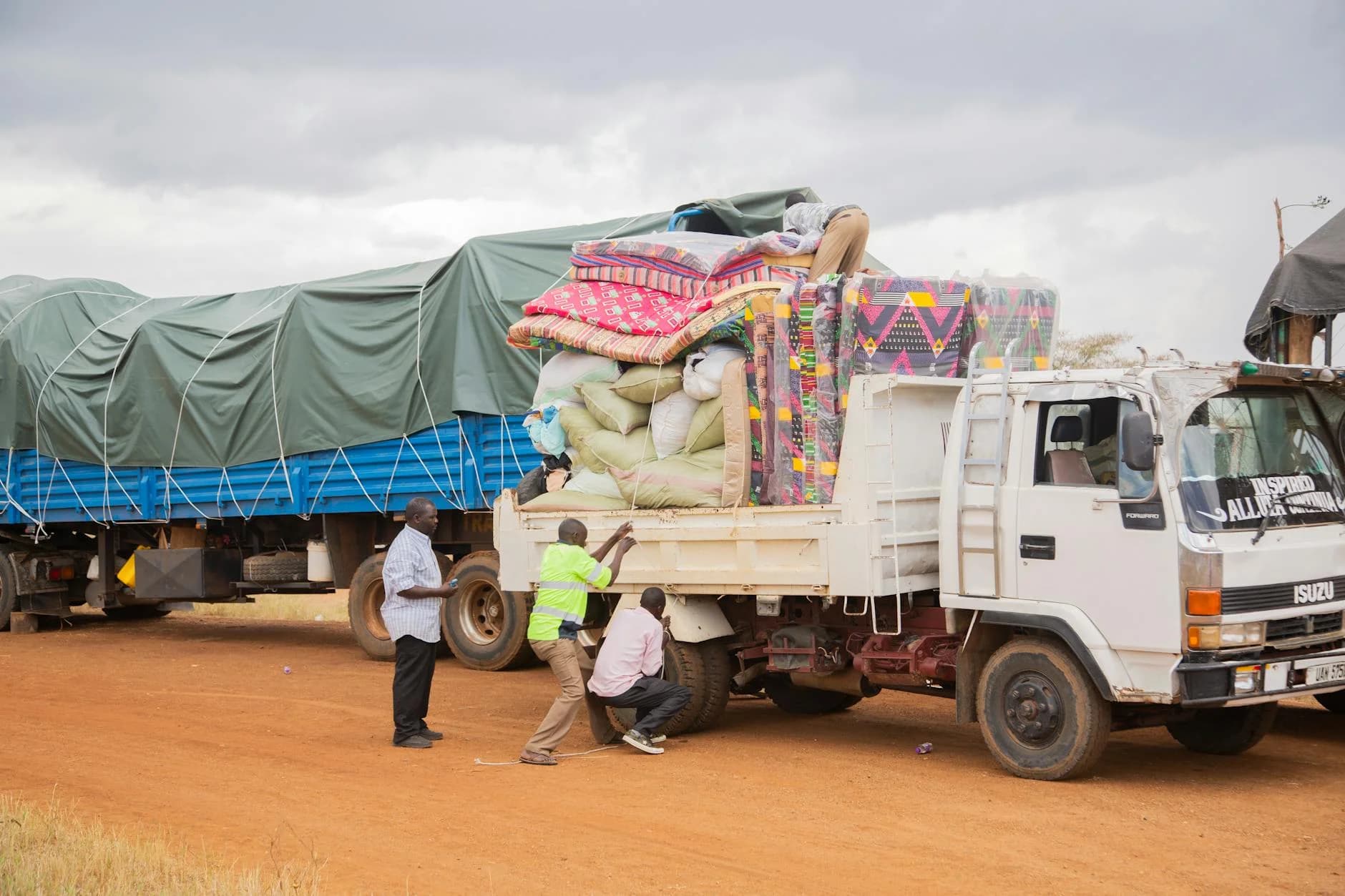 People Loading Supplies Onto A Truck In 3