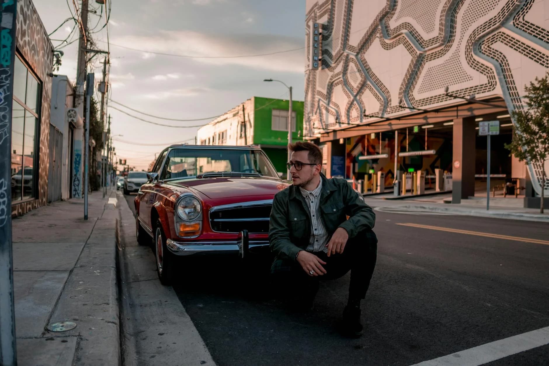Man Poses By A Vintage Red Car On A Miam 1