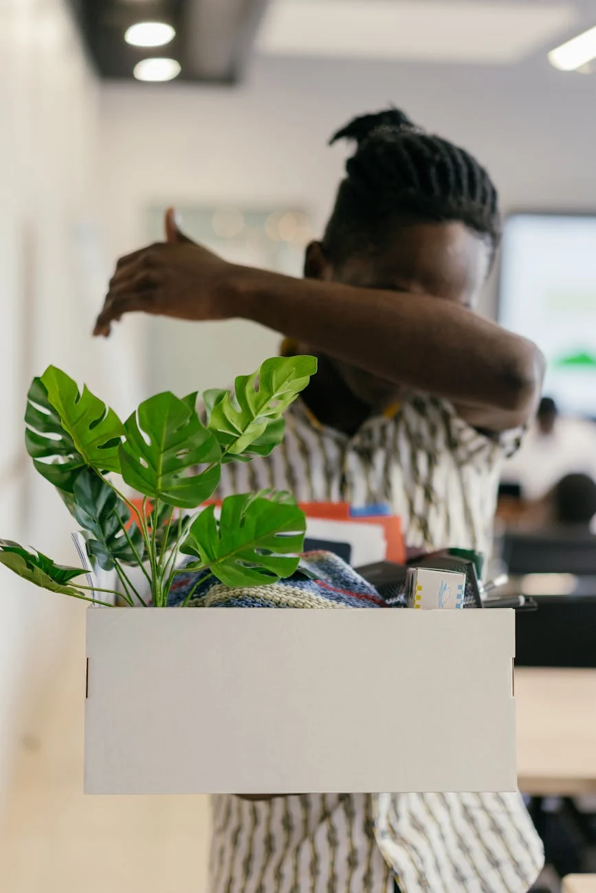 A Man In An Office Carrying A White Box 4
