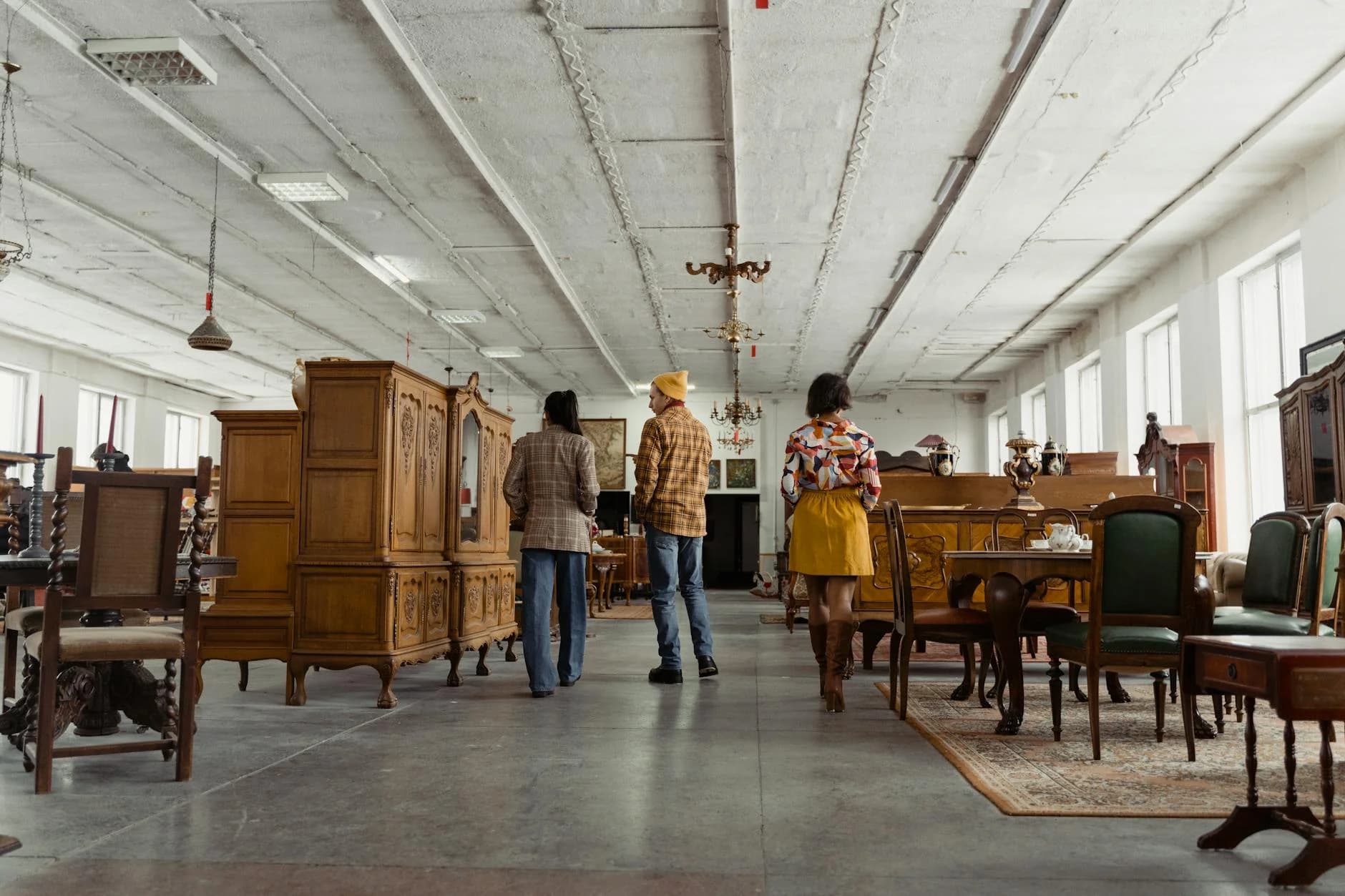 Three People Browsing Vintage Wooden Fur 1