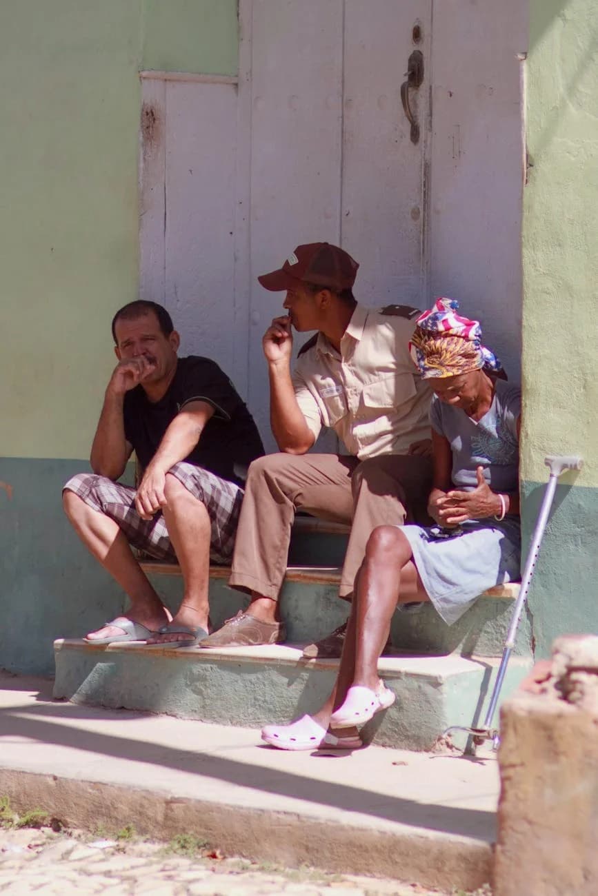 Three Adults Sitting On Steps Conversing 5
