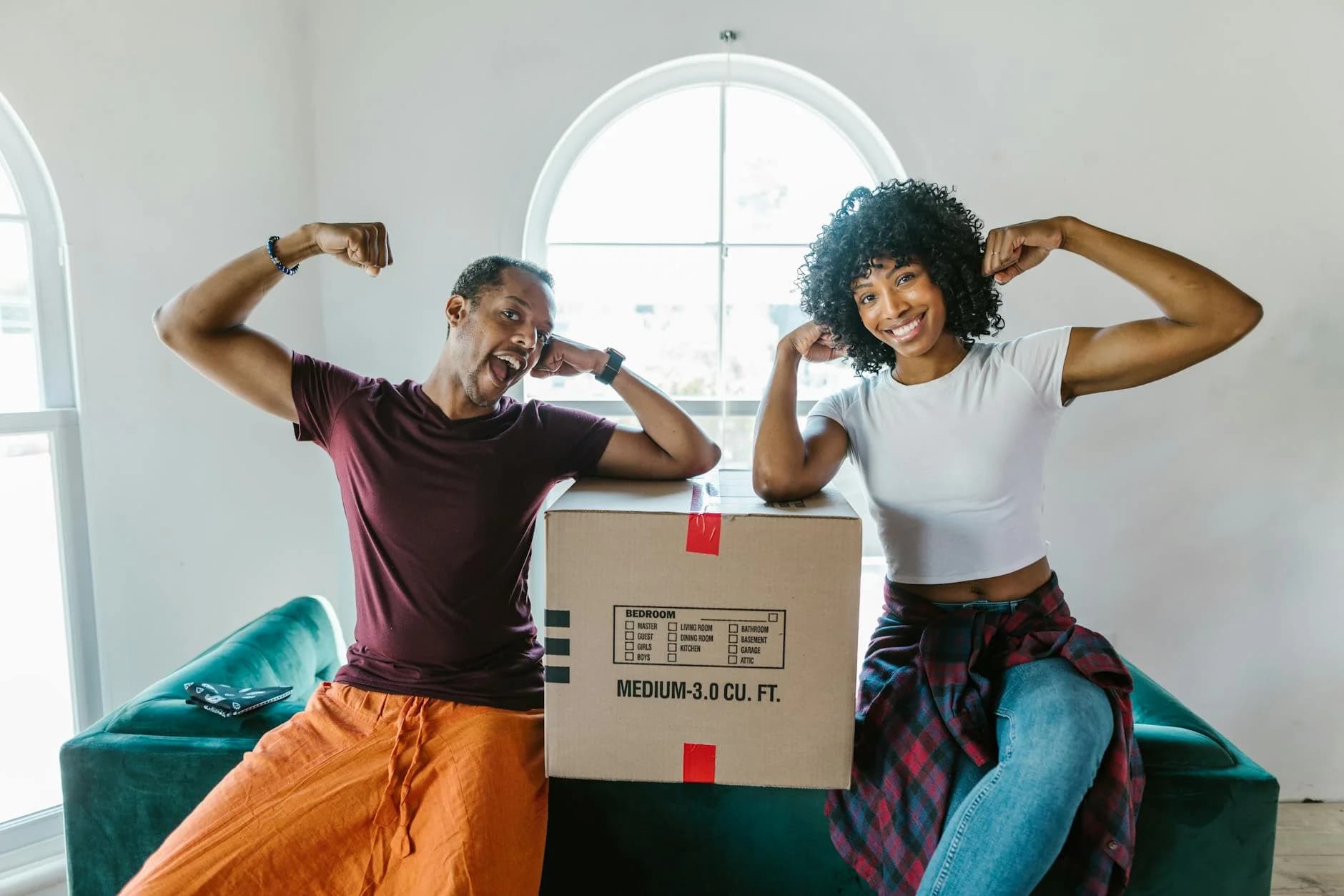 Joyful Couple Flexing Muscles While Unpa 3