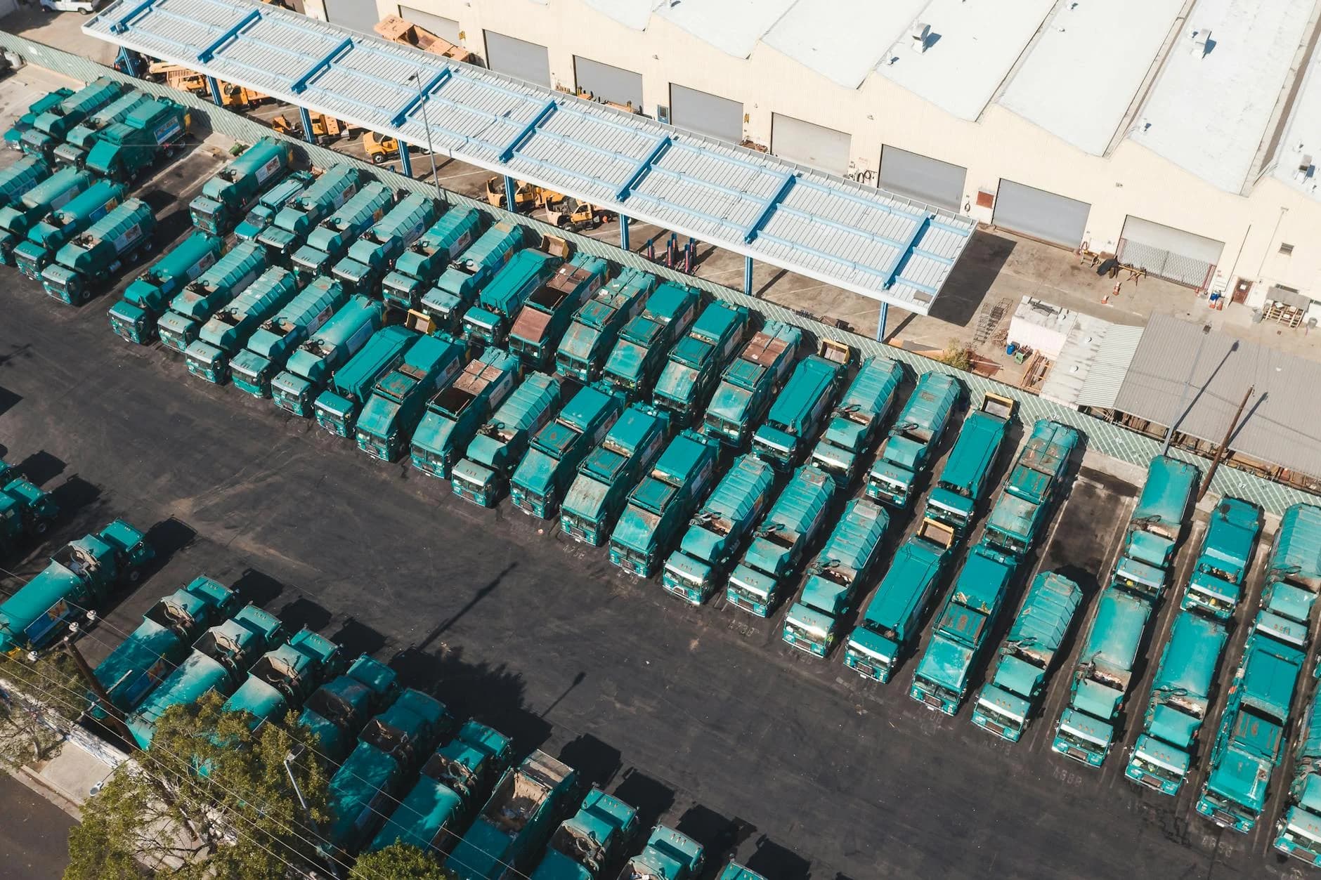 Aerial View Of Teal Trucks Lined Up In A 4