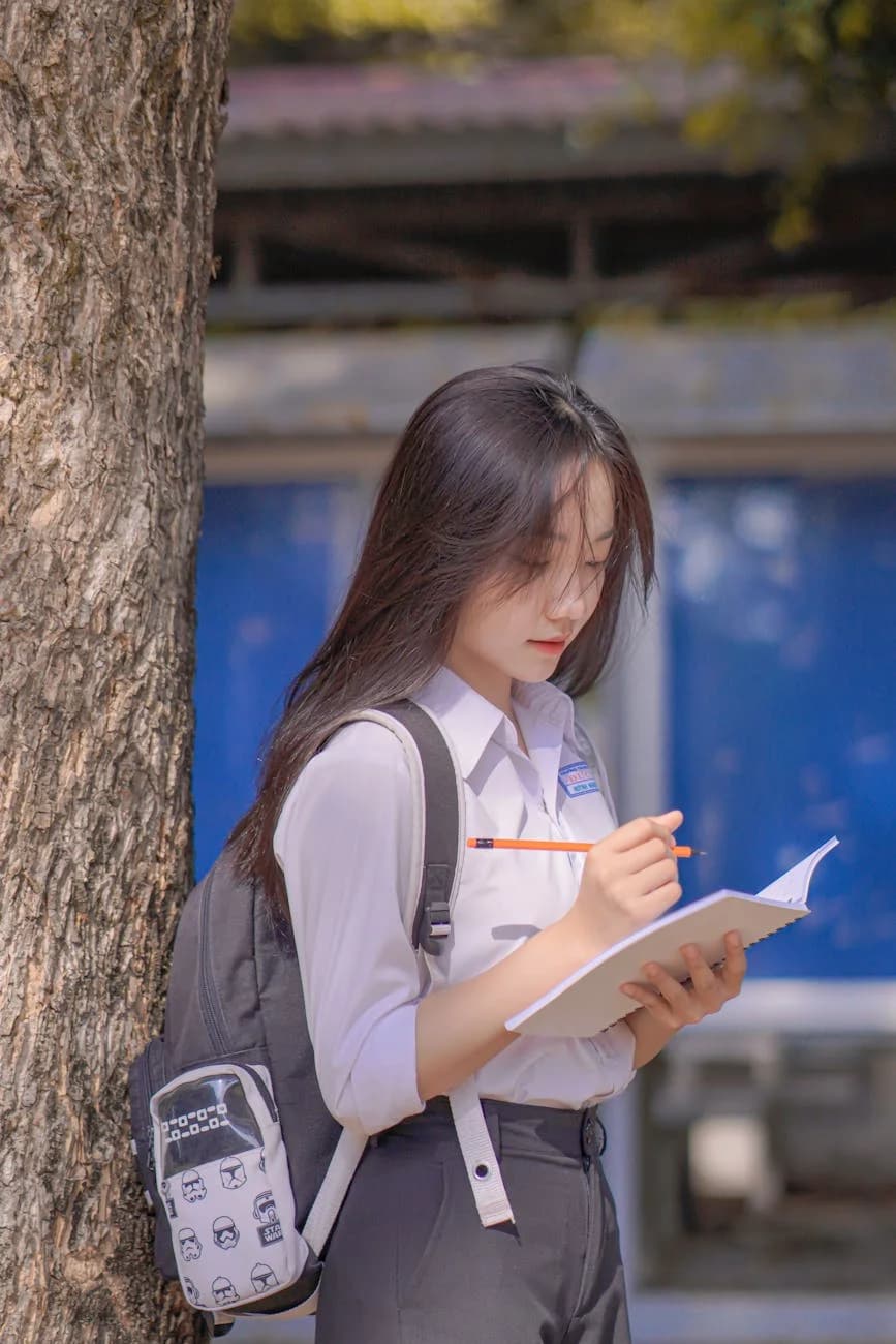 Woman Standing By A Tree With A Backpack 2