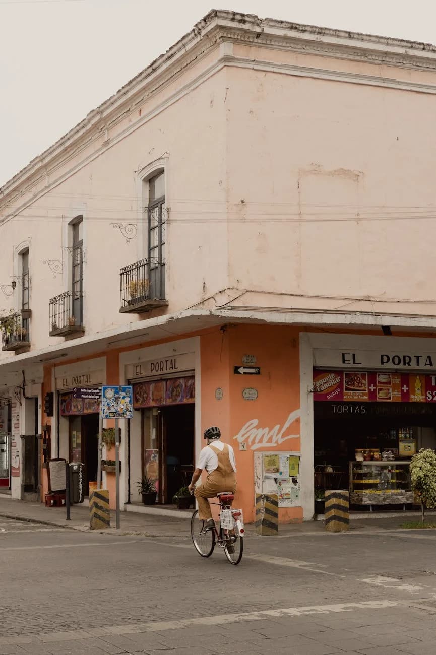 A Man Rides A Bicycle Down A Historic St 3