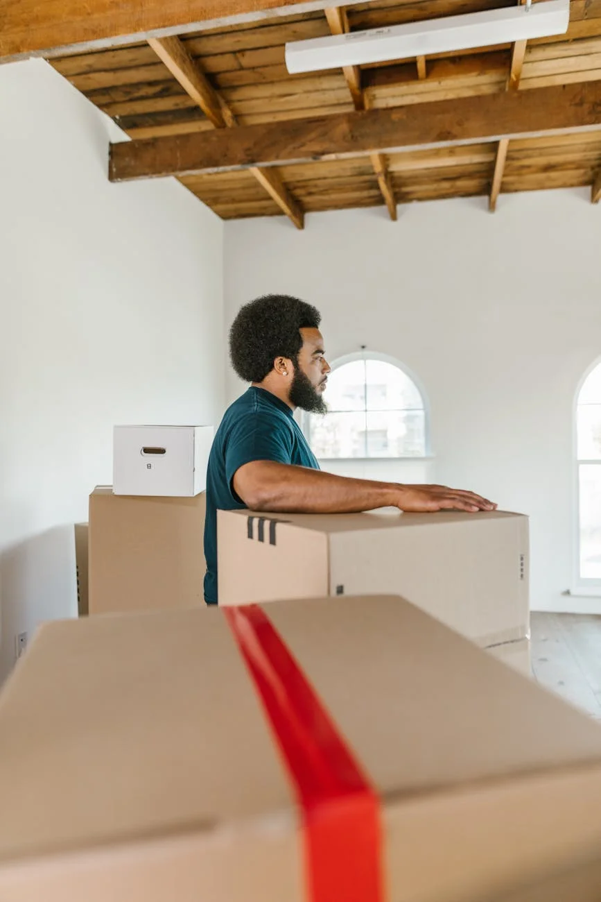 Man Handling Moving Boxes In A Spacious 3