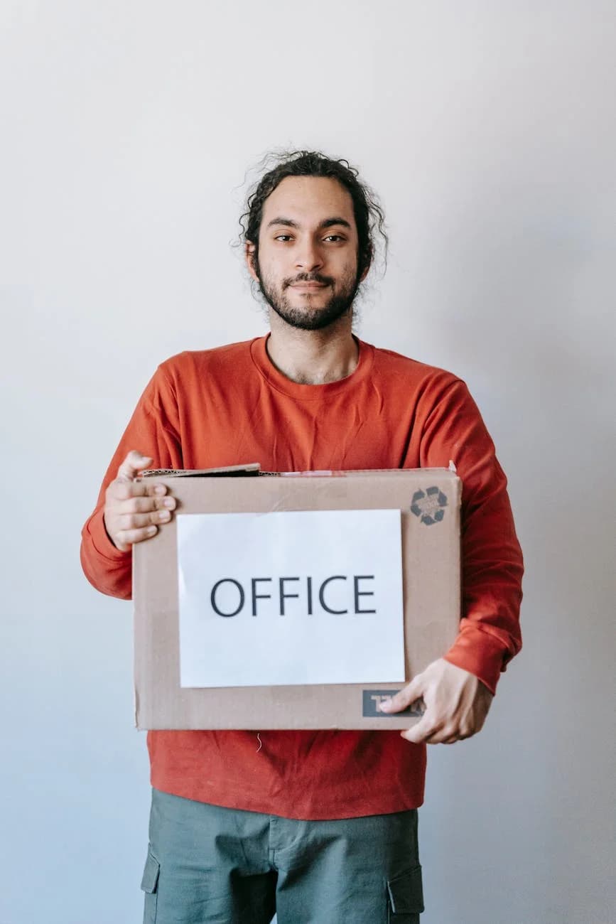 Smiling Young Man Holding A Cardboard Bo 3