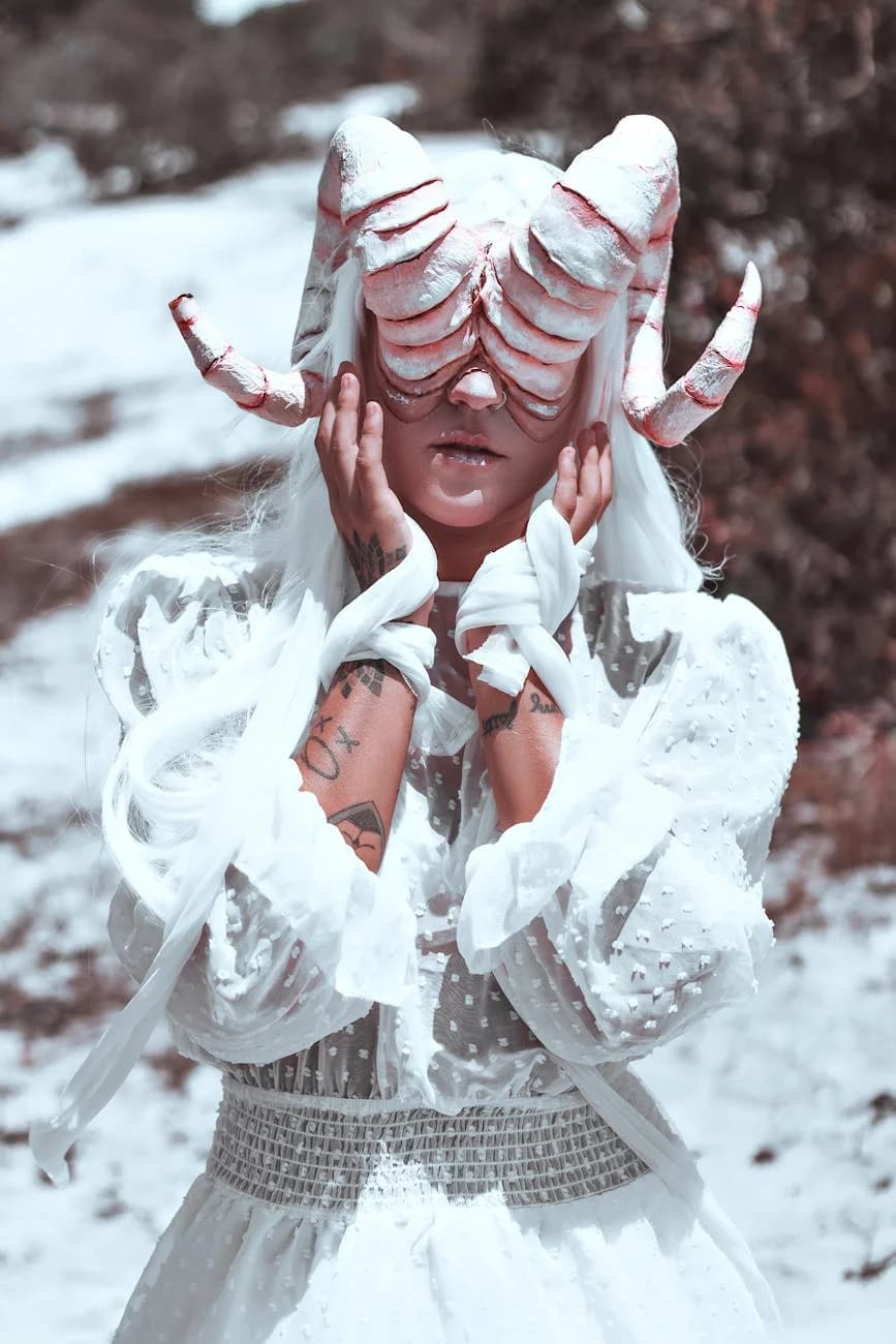 A Woman In A Surreal Horned Costume And 2