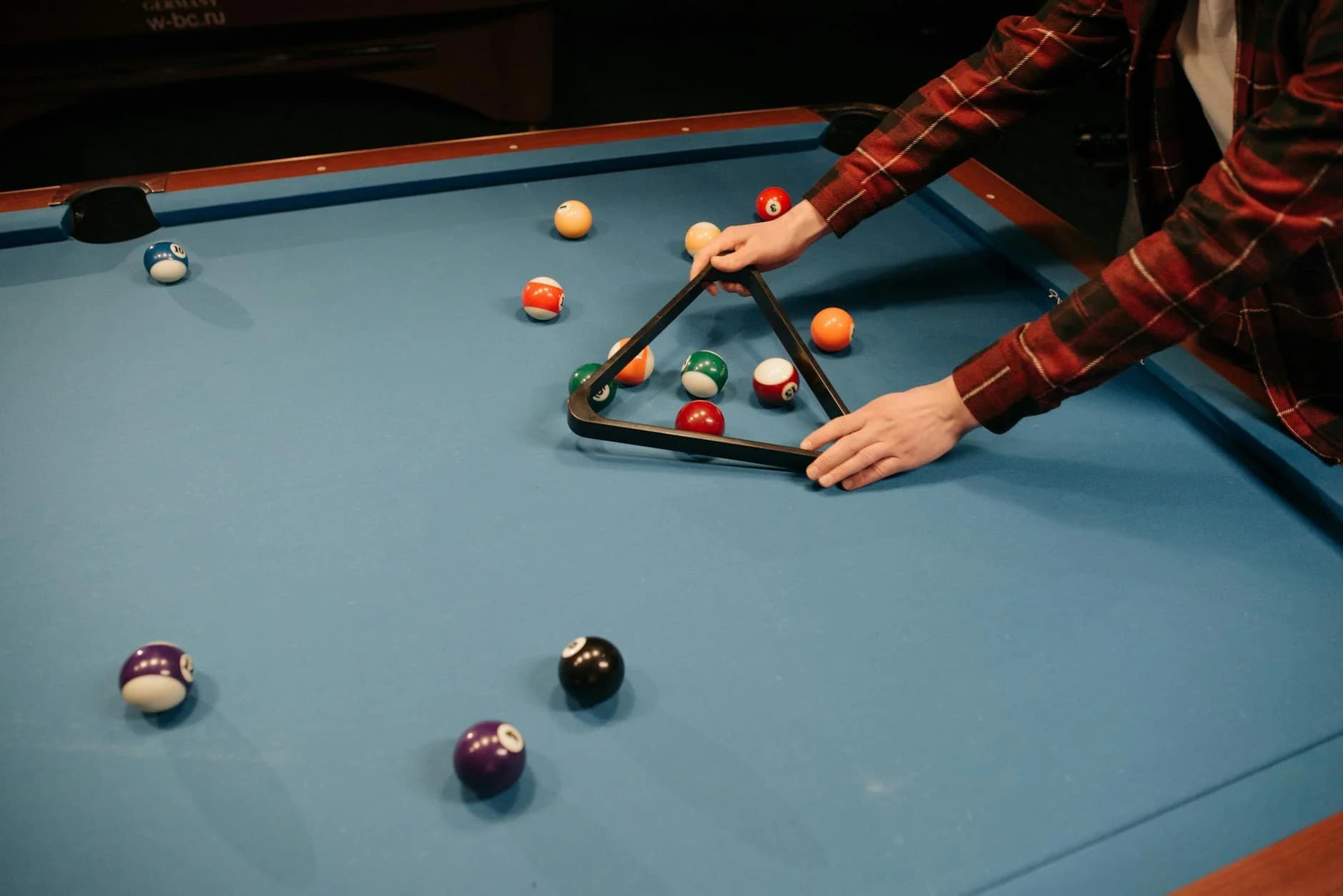 A Person Arranging Billiard Balls On A B 1