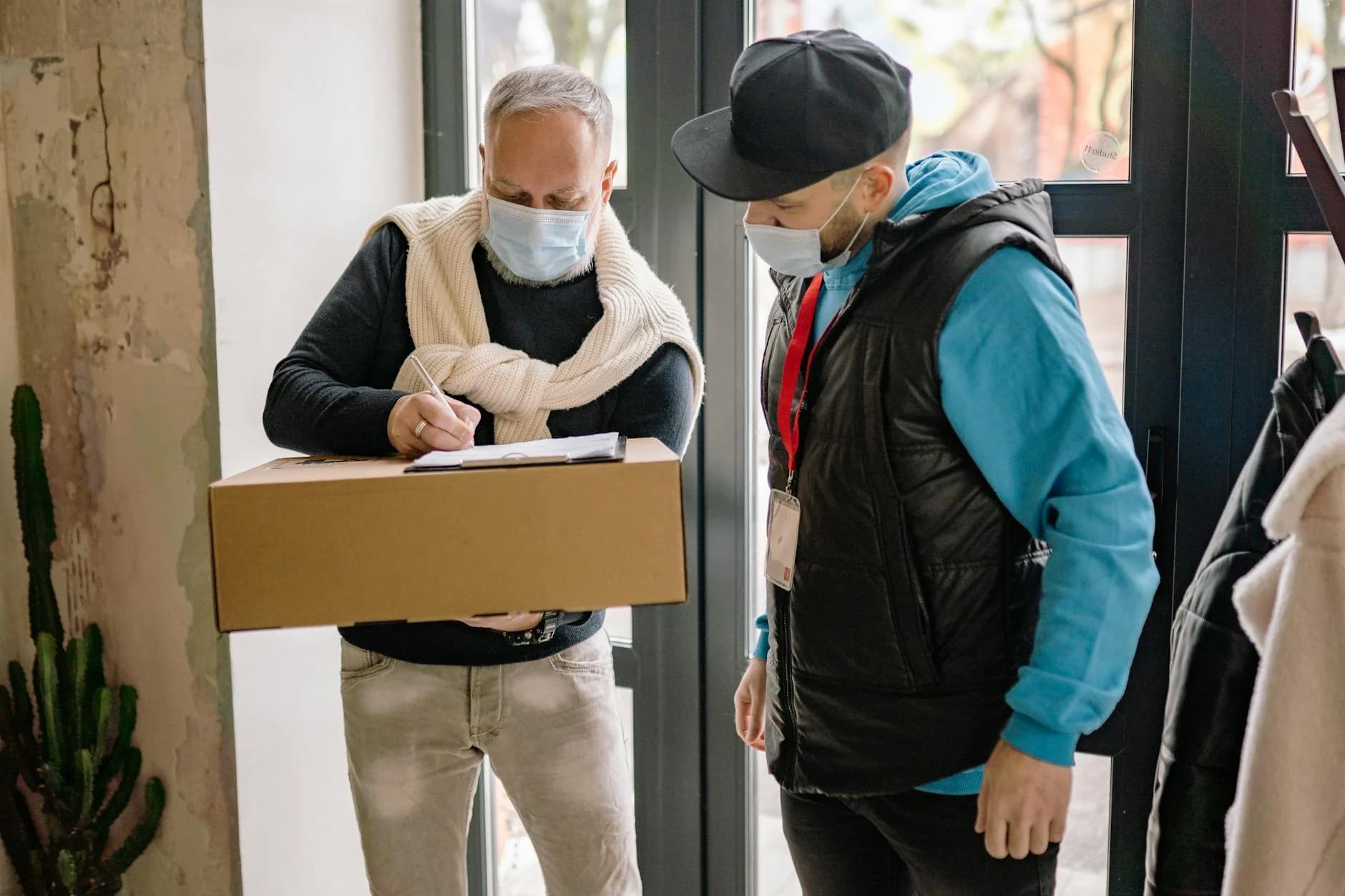 Elderly Man Signs For A Parcel While A D 4