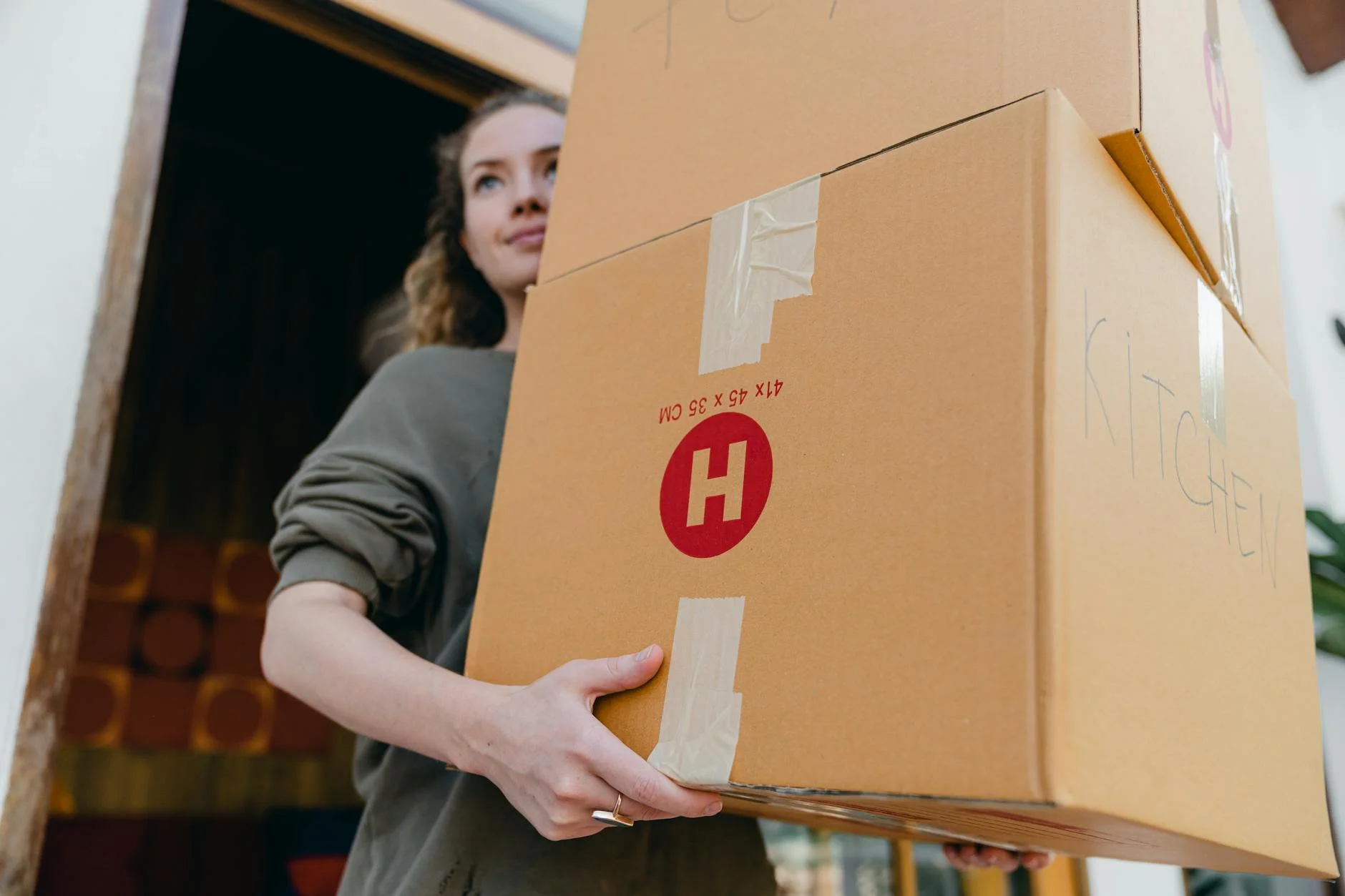 Confident Young Woman Carrying Cardboard 1
