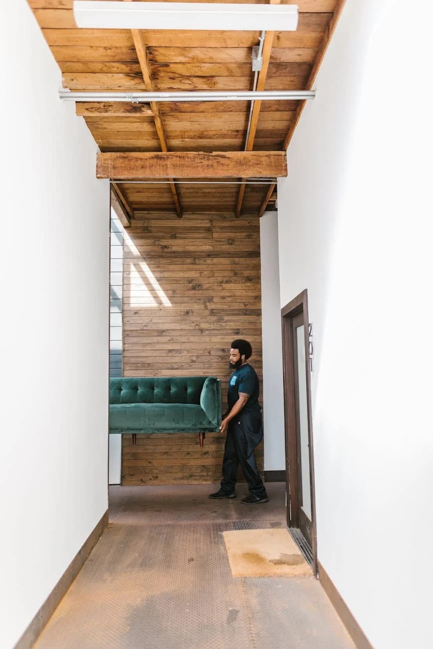 Svc A Man With Afro Hair Moves A Teal Sofa T 2