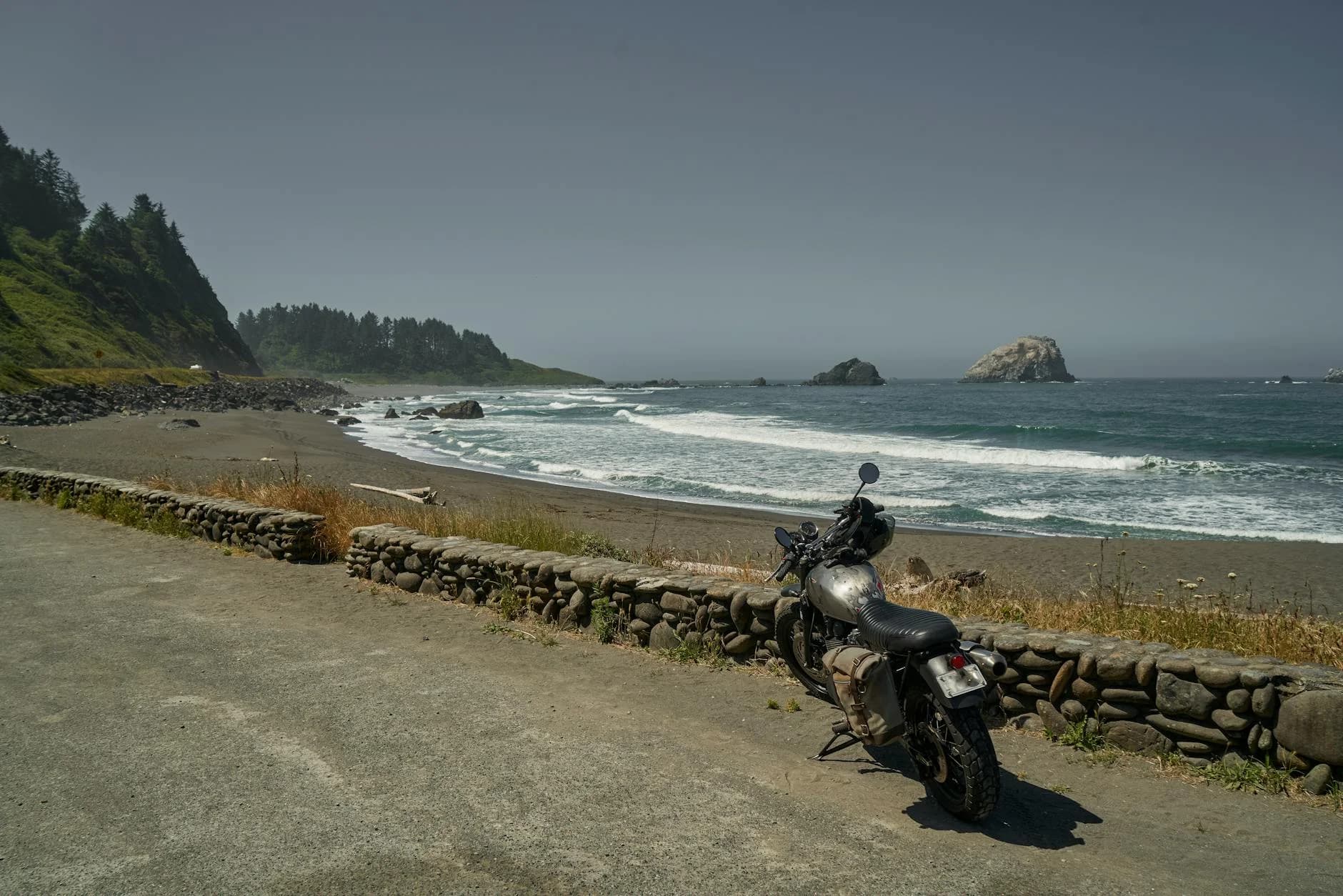 A Classic Motorcycle Parked By The Ocean 3