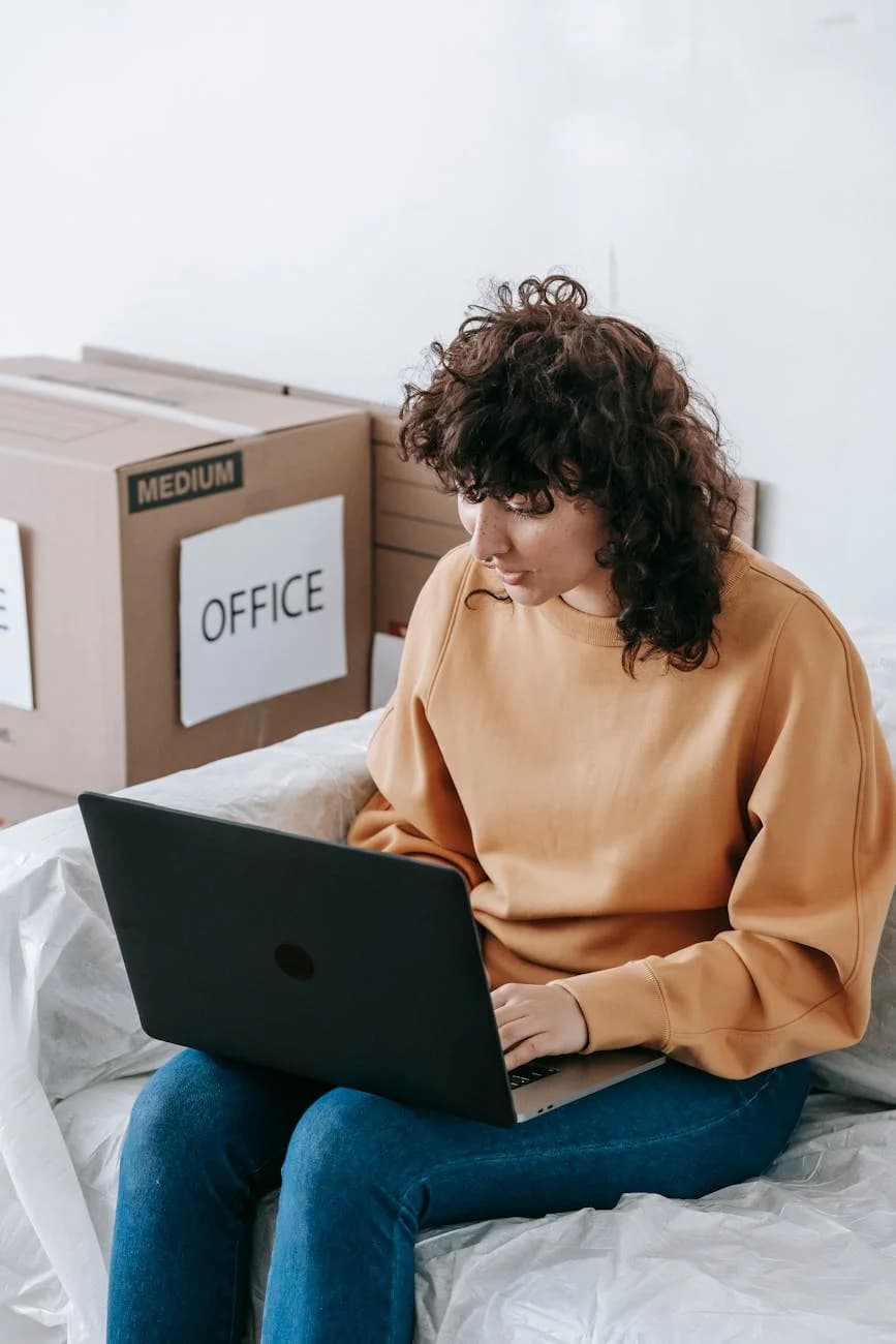 A Woman In A Casual Setting Using A Lapt 4