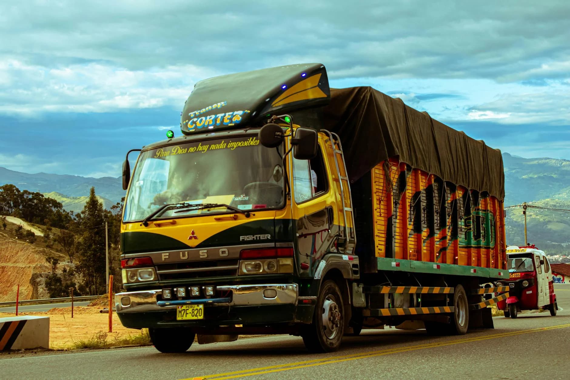 Vibrant Cargo Truck Cruising A Scenic Mo 1