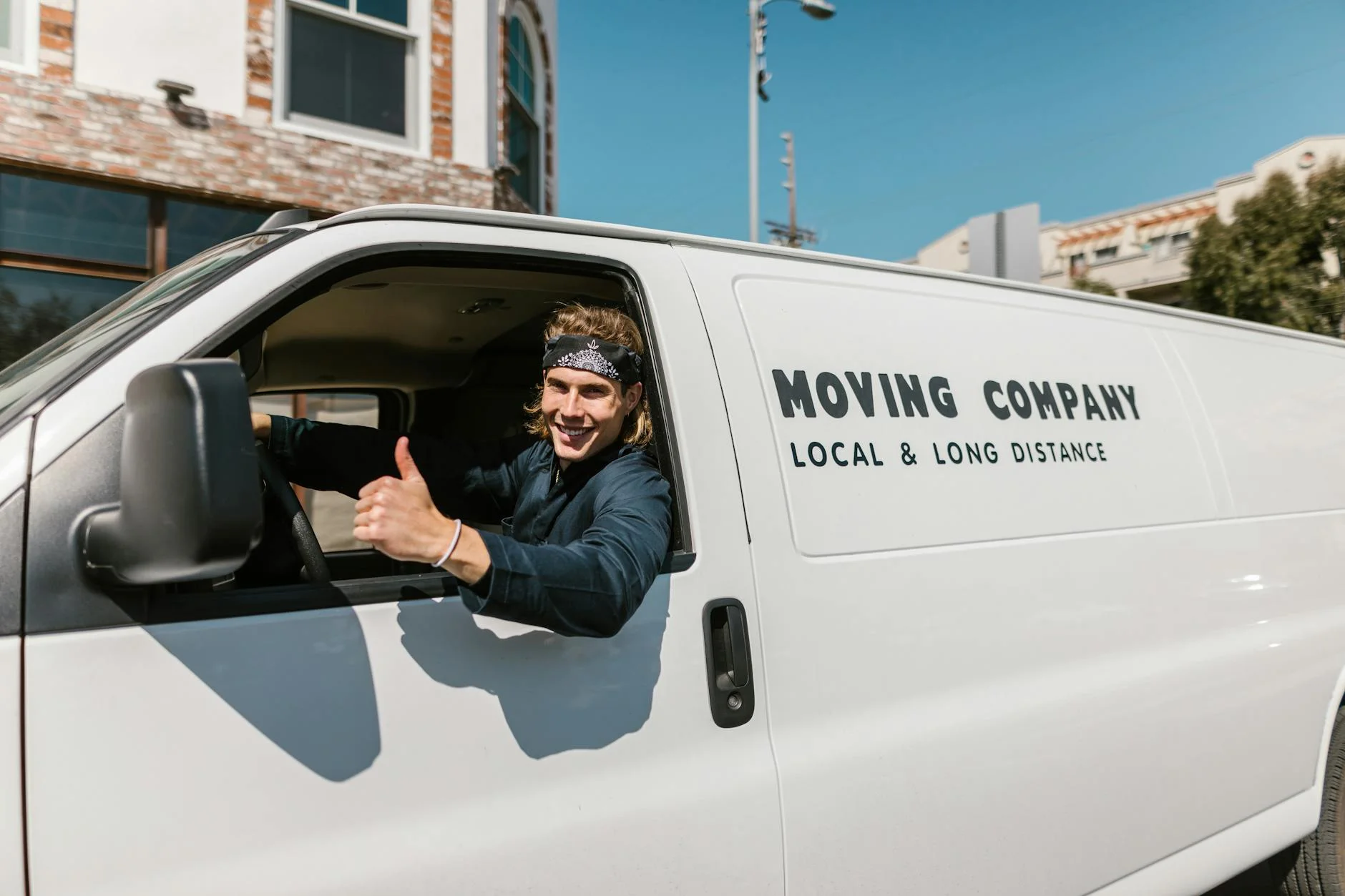 Smiling Mover Giving Thumbs Up From A Mo 2
