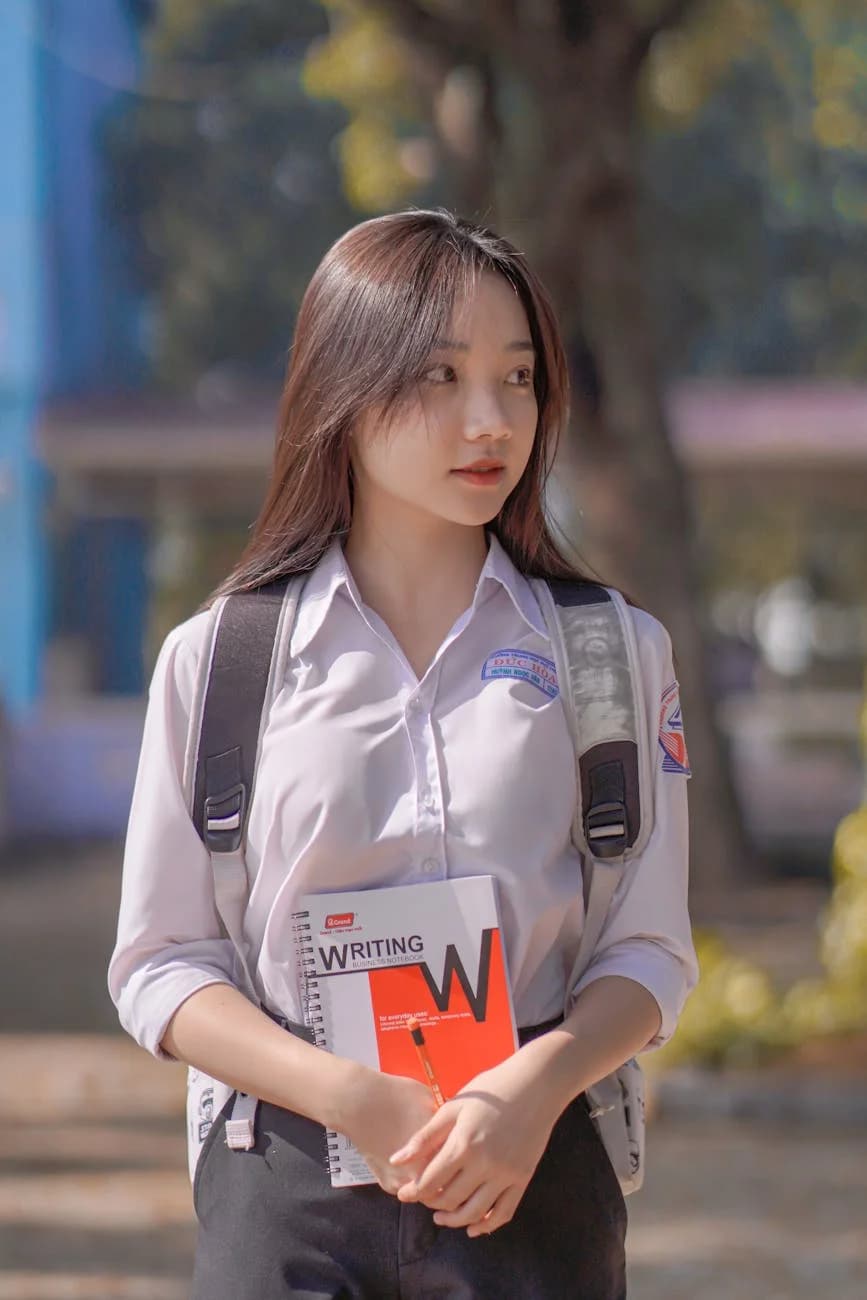 A Teenage Student In A School Uniform Ho 2
