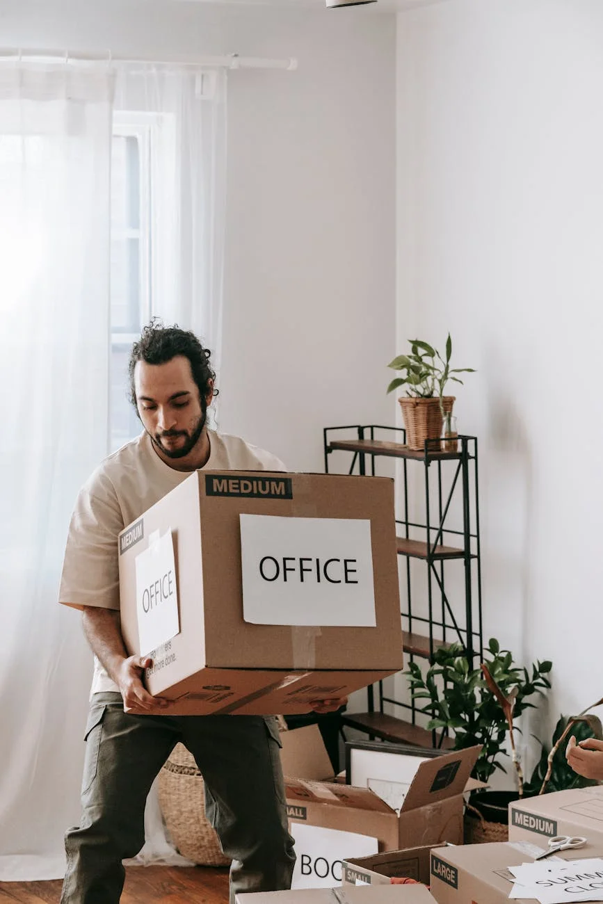 Young Man Carrying Boxes While Moving Of 3