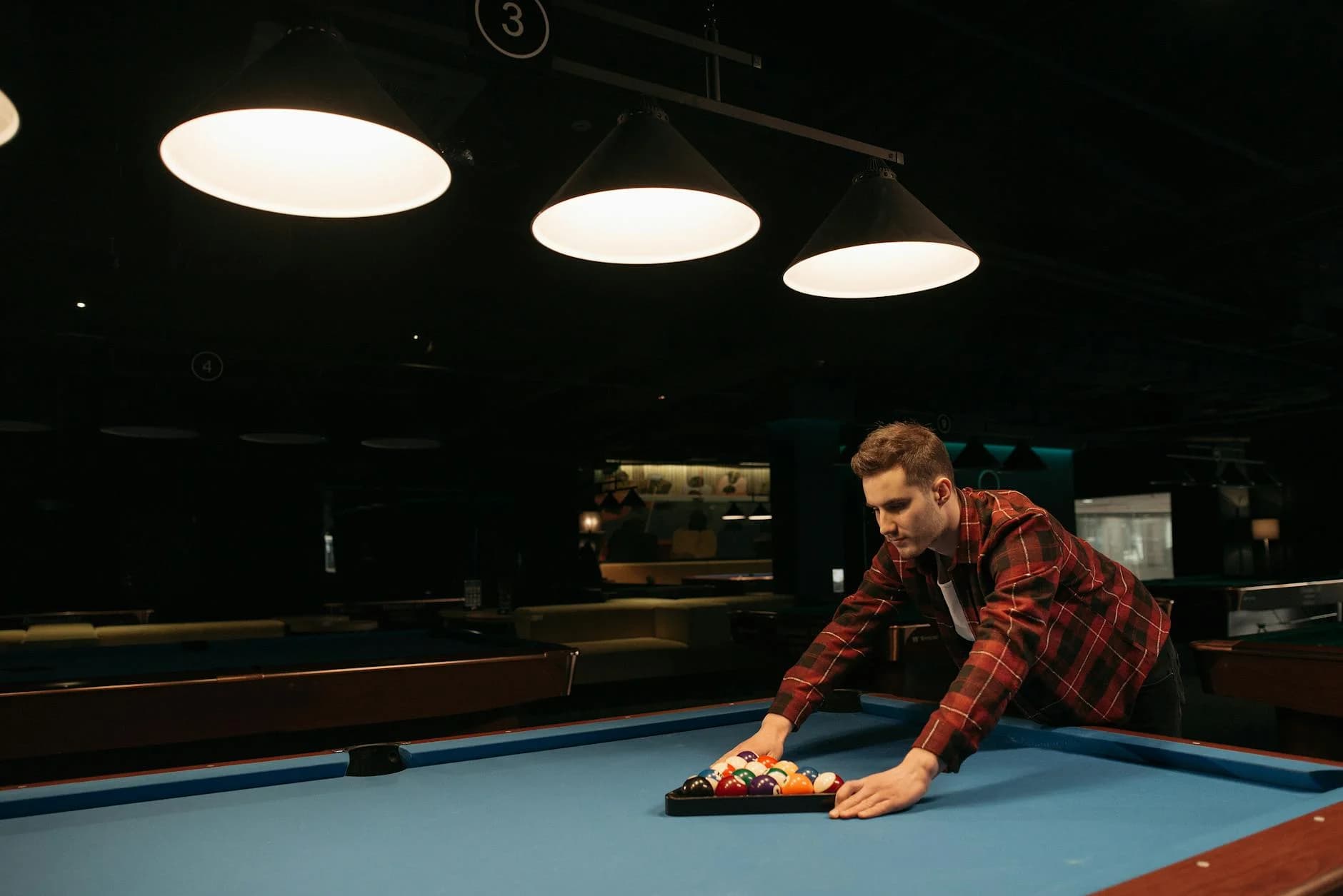 A Man Setting Up Billiard Balls On A Poo 3