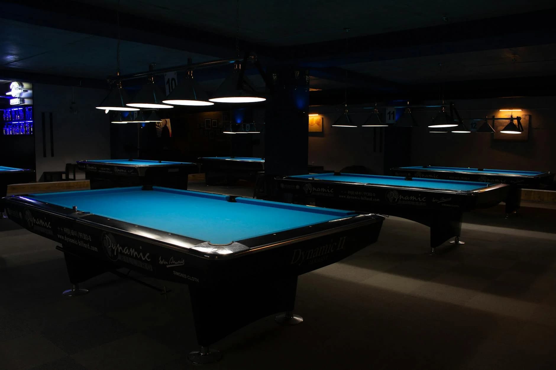 A Row Of Empty Billiard Tables In A Diml 5